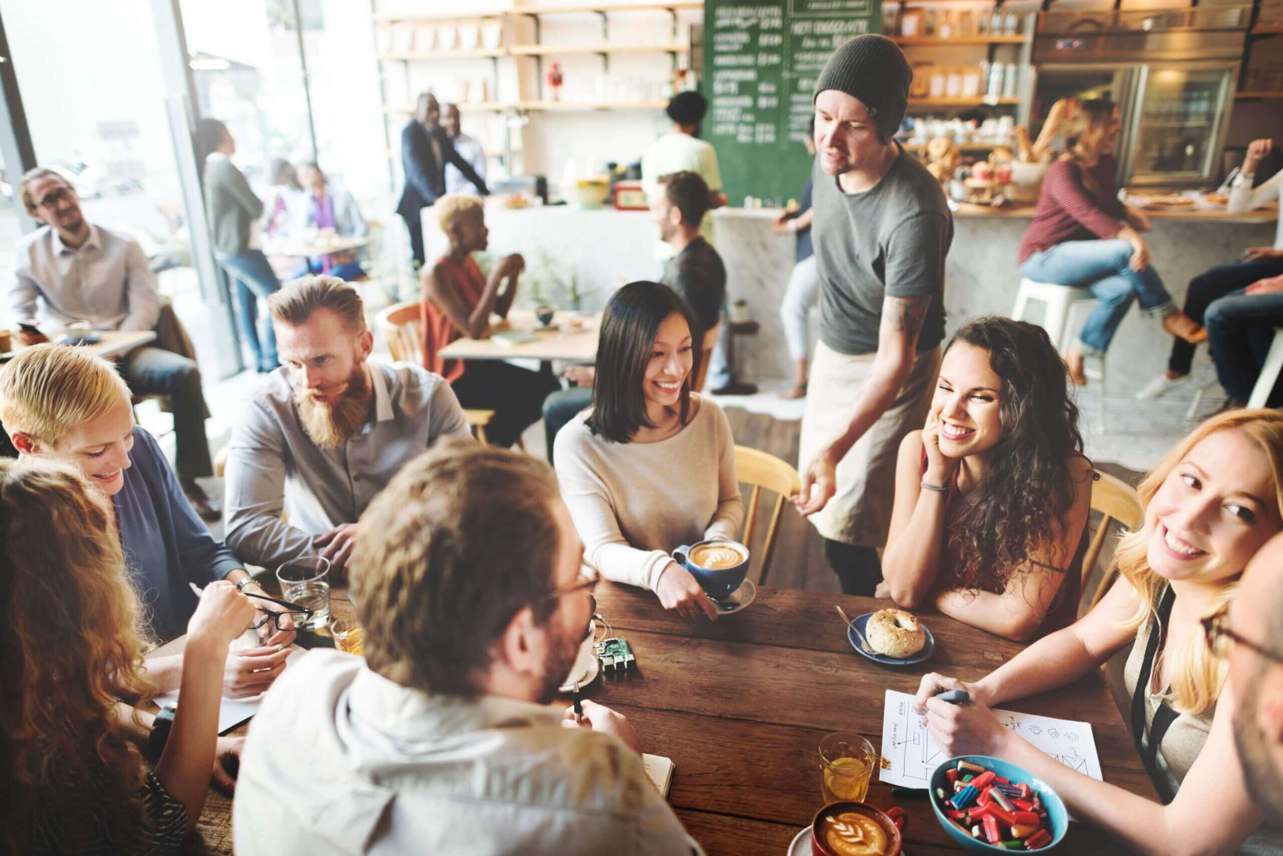 a group of happy friends at a coffee shop